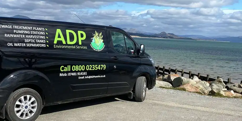 An ADP Environmental Services van parked beside the water