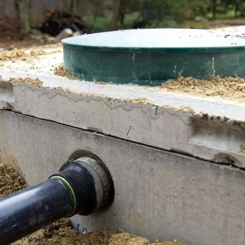 A pipe sealed where it enters a concrete chamber