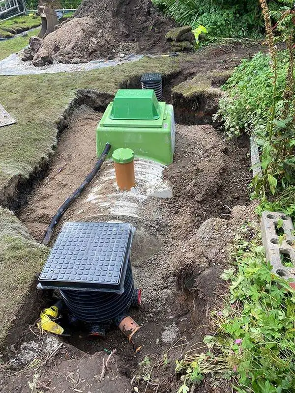 A new tank set into a garden trench and partly backfilled
