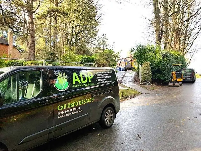 An ADP van on site with a digger working behind it